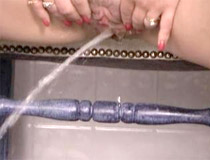 Redhead in a gynecological chair having fun with pissing