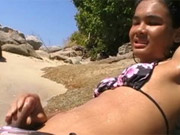 Young ladyboy masturbating to orgasm on a tropical beach