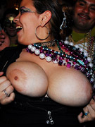 See these two babes giving him a hand job and flashing their titties