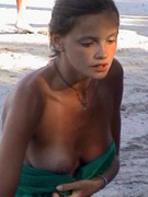 Girls have fun on the beach ripping off each other's thong